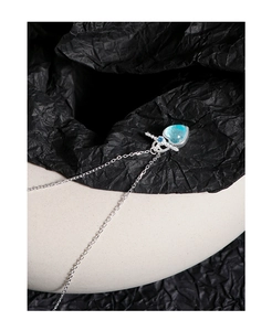 Macro shot of S925 silver necklace featuring a light blue heart pendant and star detail