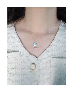 Detail of silver S925 heart necklace with blue enamel and OT toggle clasp on model