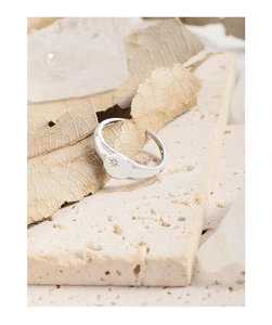 Macro shot of S925 sterling silver signet ring with engraved starburst and zircon stone