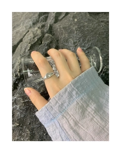 Close-up of S925 sterling silver signet ring with an engraved starburst on a stone backdrop