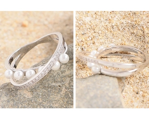 Macro detail of S925 hallmark on crossover silver ring with pearls and pavé setting