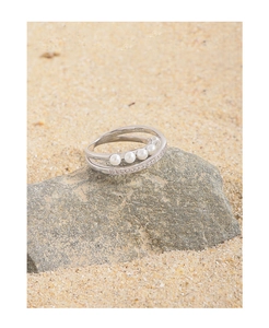 Macro view of S925 sterling silver ring featuring elegant pearls and cubic zirconia