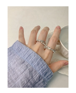Detailed view of S925 silver rings with pearls and zircon on model hand