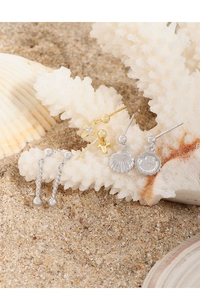 Detailed view of S925 silver shell and cross stud earrings with hallmark stamp