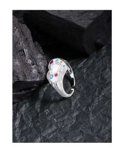 Macro shot of S925 silver liquid heart ring with colorful zircon stones on charcoal
