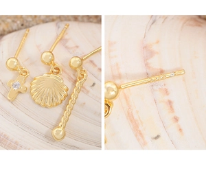Macro shot of S925 sterling silver stamp on gold shell and cross stud earrings set