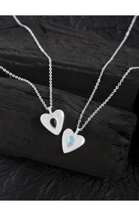 Close-up of S925 sterling silver heart necklaces with black and blue crystal pendants