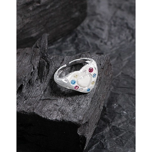 S925 silver heart ring with colorful zircon stones on a charcoal display