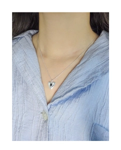 Close-up of S925 silver heart necklace with black gemstone on model collarbone