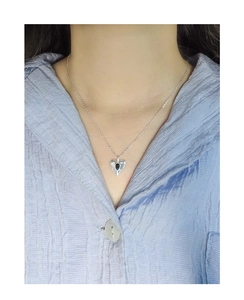 Close-up of S925 silver heart necklace with a black teardrop inlay worn on a model