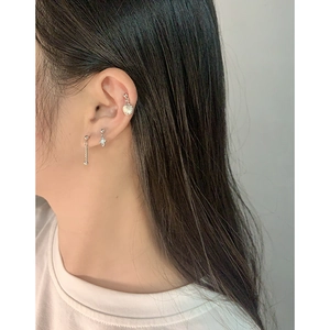 S925 sterling silver ear stud set with shell and cross charms on female model