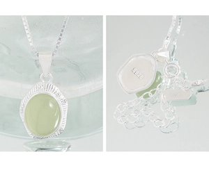 Detail of S925 sterling silver stamp and adjustable clasp on oval green crystal necklace