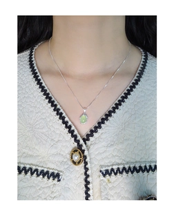 Detailed view of an oval green chalcedony pendant on a thin S925 silver chain necklace