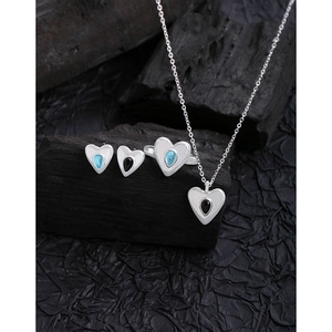 S925 sterling silver jewelry set featuring blue heart crystals on charcoal display