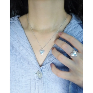 S925 silver heart necklace and ring set with light blue crystal on a model