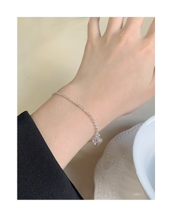Detail shot of a s925 silver chain bracelet featuring a clear pink heart crystal charm