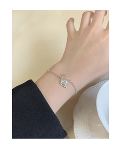 Detail of silver heart charm with pink bead on elegant S925 sterling silver chain