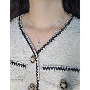 Elegant S925 silver necklace featuring an irregular oval green crystal pendant on a model