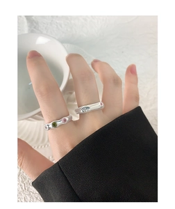 Close-up of S925 silver irregular rings with colorful zircon stones on woman hand