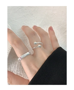 Close-up of S925 sterling silver rings with pink zircon on creamy fabric background
