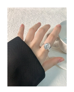 Detail view of S925 sterling silver ring with sparkling grey oval gemstone on finger
