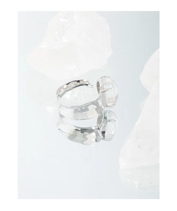 Macro detail of S925 sterling silver ring with irregular texture and round crystal stone