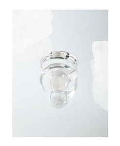 Macro shot of S925 silver ring featuring an irregular oval crystal on a sleek mirror base
