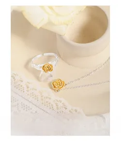 Close-up of S925 sterling silver rose flower ring and necklace set with gold plating