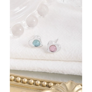 Asymmetric S925 silver heart stud earrings with blue and pink crystal on white fabric