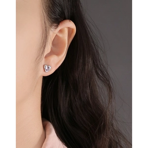 Elegant S925 silver heart stud earrings with purple crystal shown on model