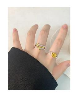Detail of S925 silver rose and double-layer heart rings on a female model's hand