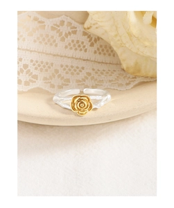 Macro shot of silver tree branch texture ring with a golden rose flower detail