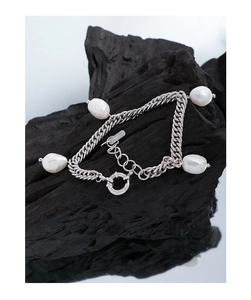 Macro shot of S925 sterling silver stamp on a double chain baroque pearl bracelet