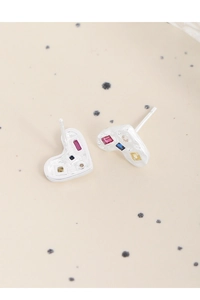 Detail of S925 sterling silver heart earrings with colorful zircons on polka dot plate