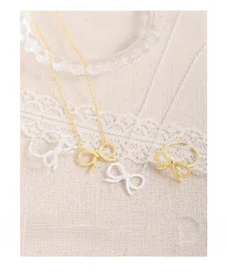 Detail of Korean style S925 silver hollow bow pendant necklace and matching open rings