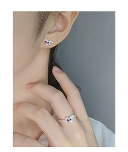 Detailed close-up of S925 silver heart earrings and ring with colorful zircon gemstones