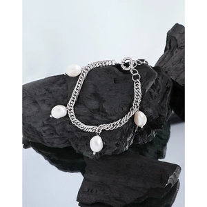 Baroque pearl sterling silver chain bracelet displayed on black volcanic rock texture