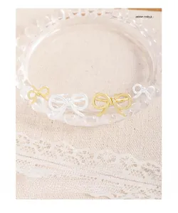 Macro view of textured bow ring with twisted rope weave in gold and silver finish