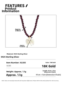 Macro detail of S925 sterling silver dog pendant necklace with purple garnet beads