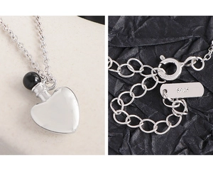 Close-up of S925 sterling silver perfume bottle heart necklace showing the hallmark