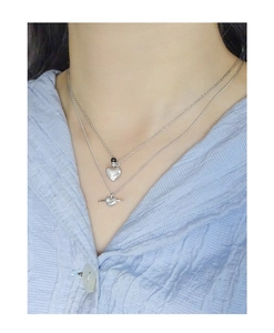 Close-up of double-layer S925 silver necklace featuring heart and saturn pendants
