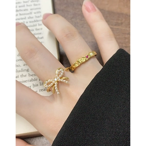 Elegant gold S925 silver ring set with pearl bow and colorful gemstones on female model