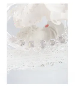 Detail view of 925 silver stud earring set with moonstone gems on elegant glassware