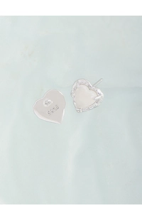 Macro detail of S925 sterling silver stamp on heart earrings with white agate texture