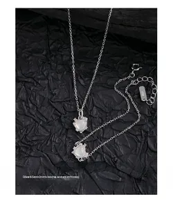 Macro detail of S925 sterling silver heart necklace with white opal and small diamonds