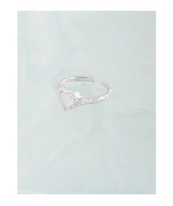 Macro detail of S925 sterling silver ring featuring heart agate and lava texture finish