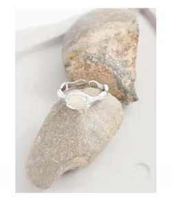 Macro shot of S925 sterling silver ring with organic lava texture and oval moonstone