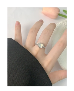 Detail of S925 silver heart ring with liquid metal texture and moonstone on hand