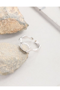 Close-up of S925 silver ring with irregular lava texture and oval white agate stone