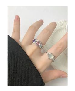 Close-up of S925 silver rings with heart moonstone and textured hammer-finished metal band